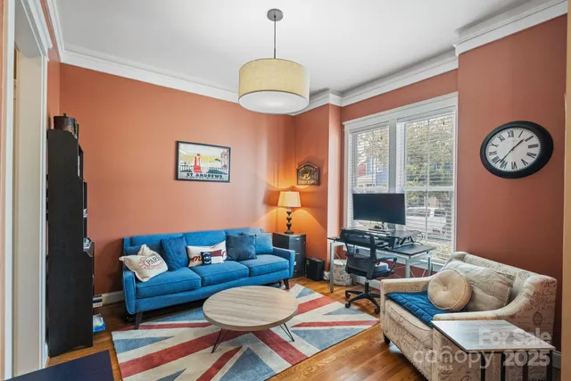 a living room with furniture a rug and a window