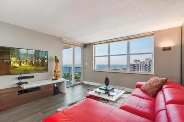 a living room with furniture and floor to ceiling window