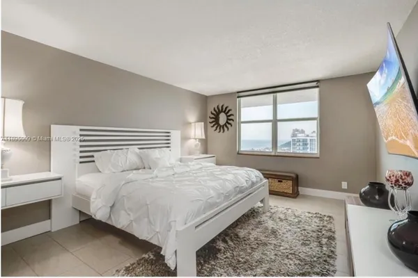 a bedroom with a bed window and a dresser