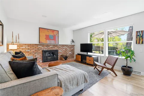 a living room with furniture fireplace and flat screen tv