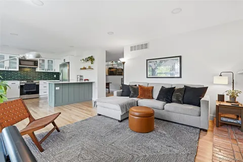 a living room with furniture a rug and a fireplace