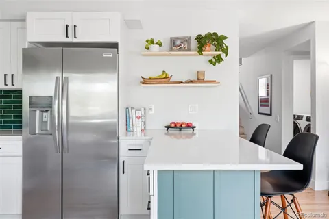 a kitchen with refrigerator and cabinets