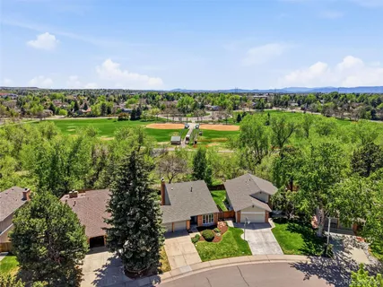 an aerial view of a house with a garden and lake view