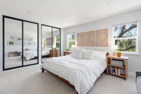 a bedroom with a bed and a large window