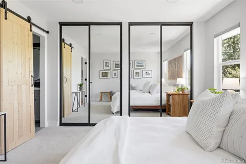 a bedroom with a large bed and a large window