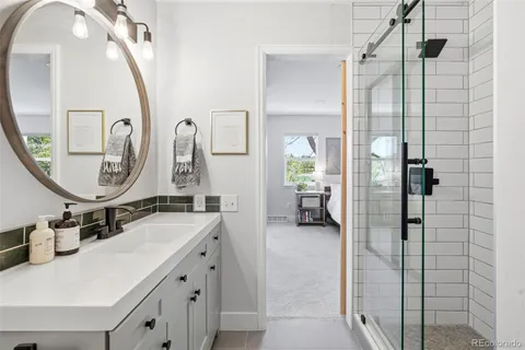 a en suite bathroom with a double vanity sink and a mirror