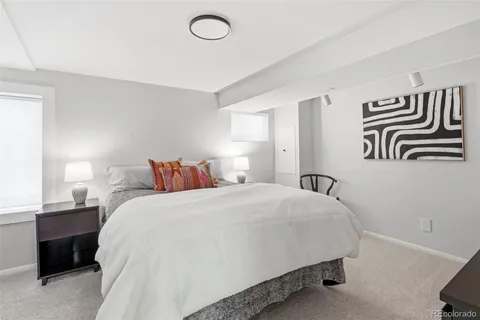 a bedroom with a bed and a painting on the wall