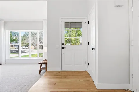 a view of a livingroom with wooden floor and a window
