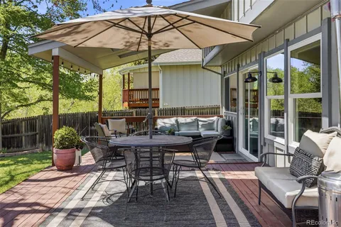 a patio with a patio table and chairs