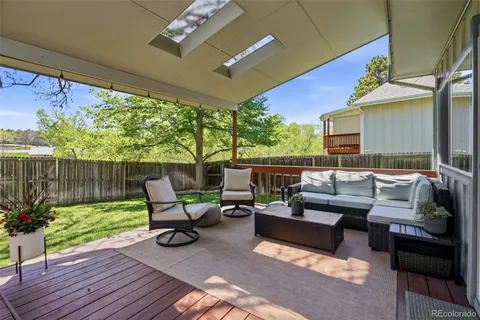 a building outdoor space with patio furniture and potted plants