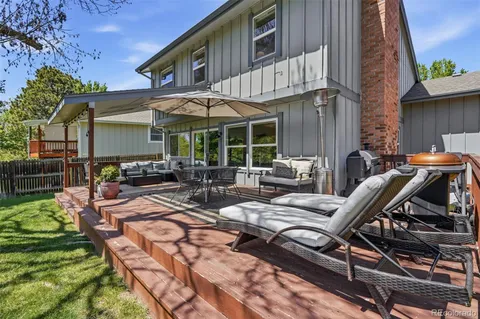 a view of a patio with table and chairs and potted plants