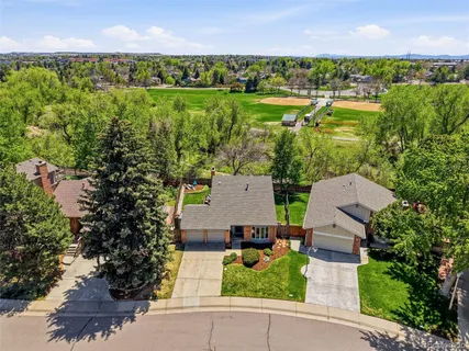an aerial view of a house with a yard and lake view