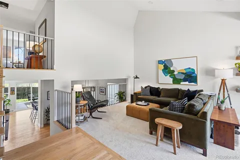 a living room with fireplace furniture and a wooden floor