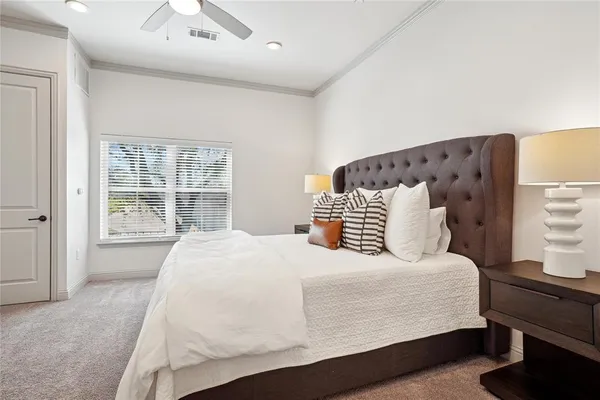 a bedroom with a large bed and a window
