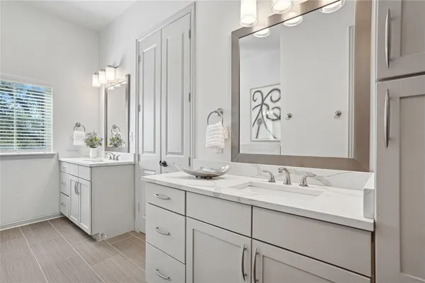 a bathroom with a double vanity sink mirror and double