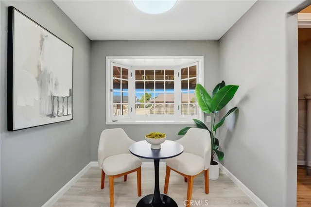 a view of a workspace with furniture and a potted plant