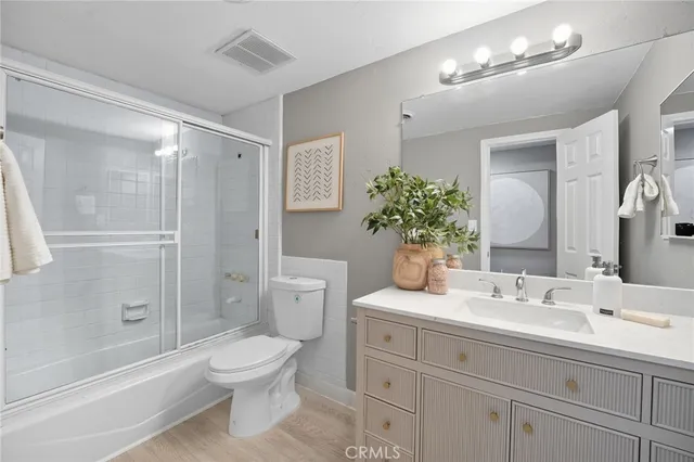 a bathroom with a toilet sink and shower