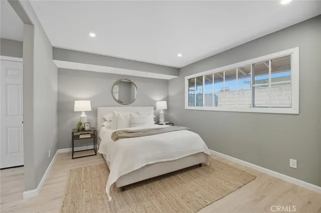 a bedroom with a large bed and a window