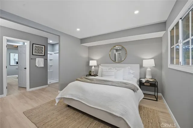 a bedroom with a bed and a lamp