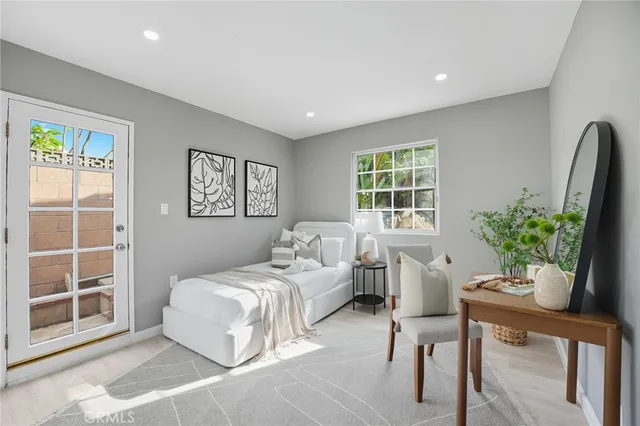 a bedroom with a bed and a potted plant