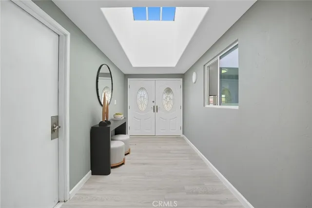 a view of a hallway with wooden floor and entryway