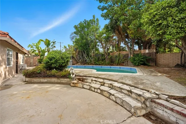 a view of a backyard with plants and a patio