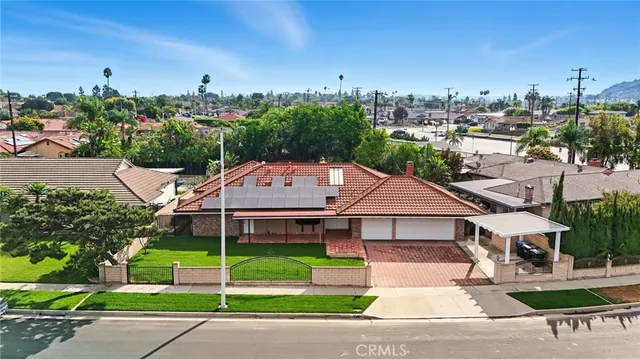 a view of a house with a yard and plants