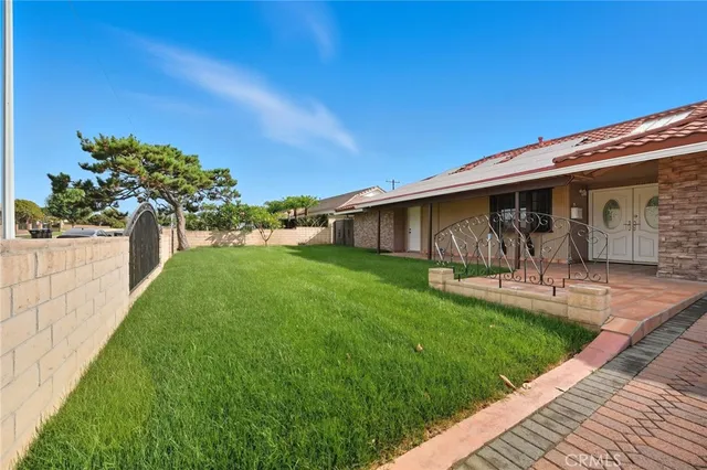an aerial view of a house with a yard and garden