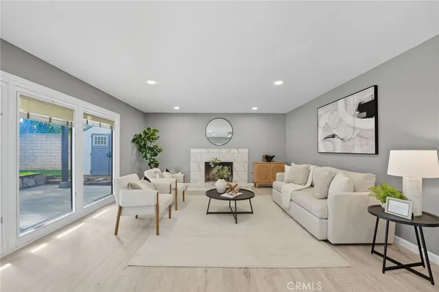 a living room with furniture couches and a large window