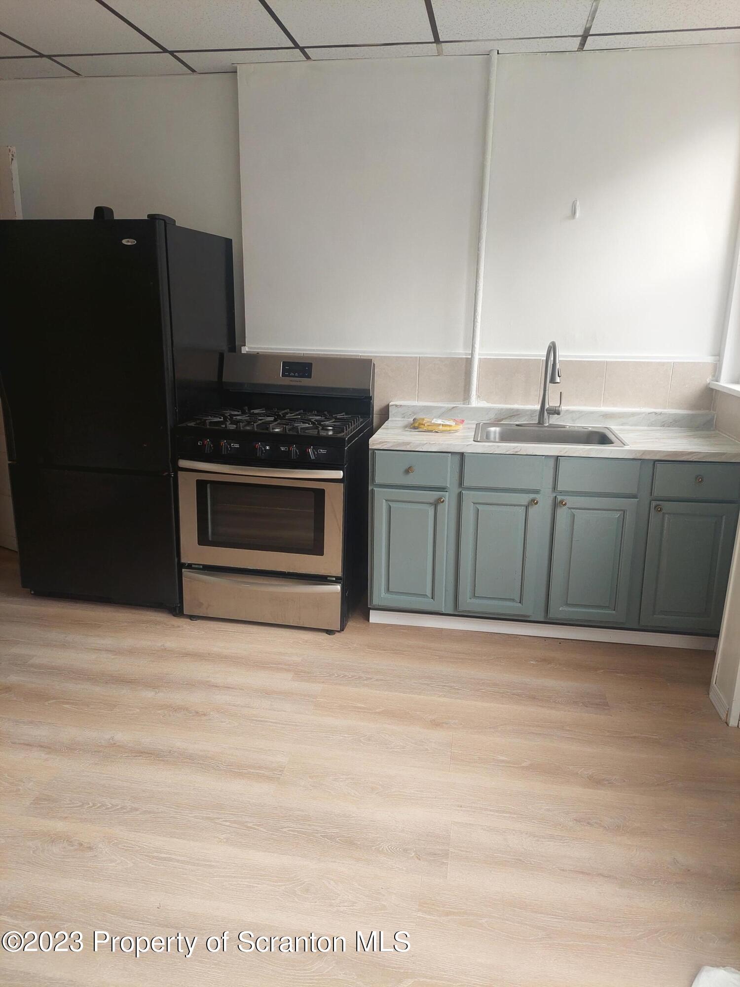 1703 Cedar Avenue Scranton, PA 18505 - Photo 12 of 14 a kitchen with stainless steel appliances granite countertop a stove a sink and a refrigerator