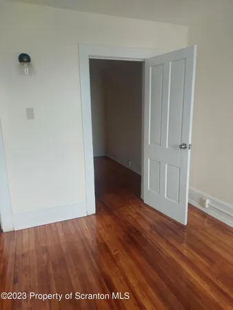 an empty room with wooden floor