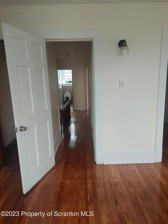 a view of a hallway view with wooden floor