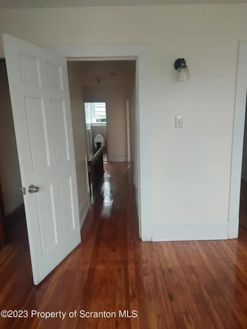 a view of a hallway view with wooden floor
