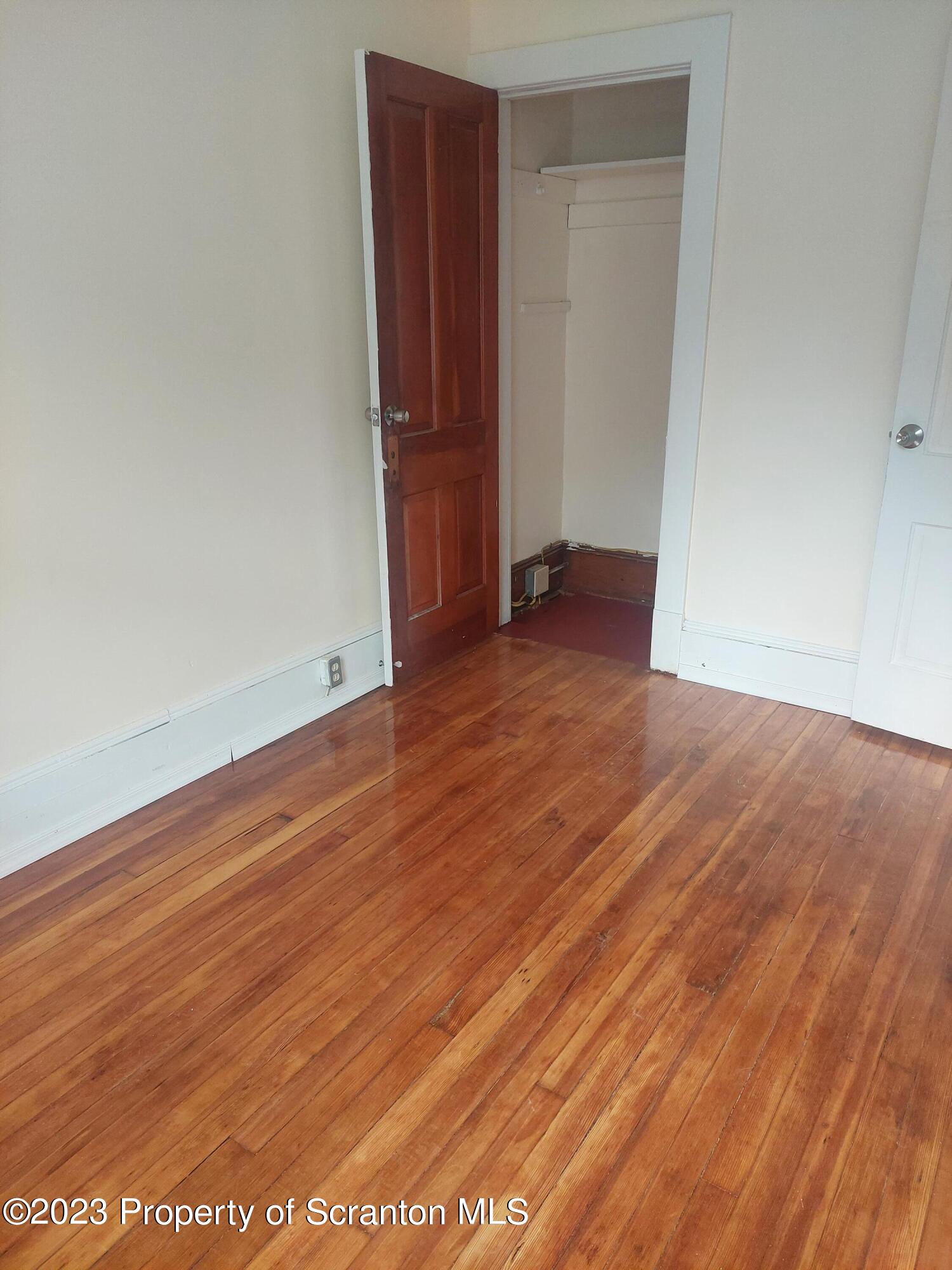 1703 Cedar Avenue Scranton, PA 18505 - Photo 6 of 14 an empty room with wooden floor and closet