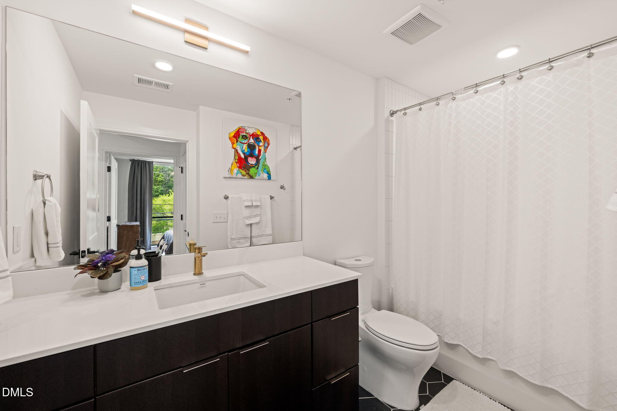 615 West Peace Street, Unit 207 Raleigh, NC 27605 - Photo 13 of 34 a bathroom with a sink a toilet a shower and a mirror
