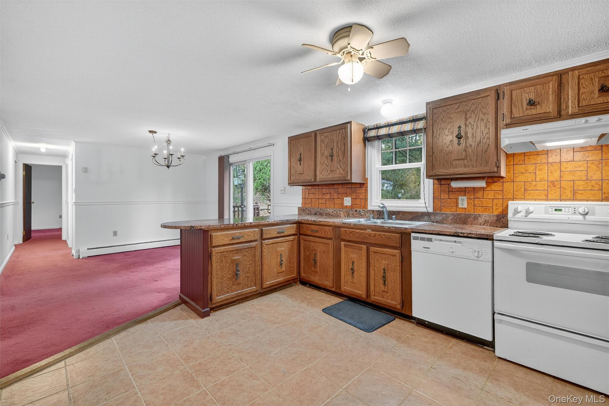 114 Laurel Hill Road Croton-on-Hudson, NY 10520 - Photo 14 of 30 a kitchen with a stove a sink and a refrigerator