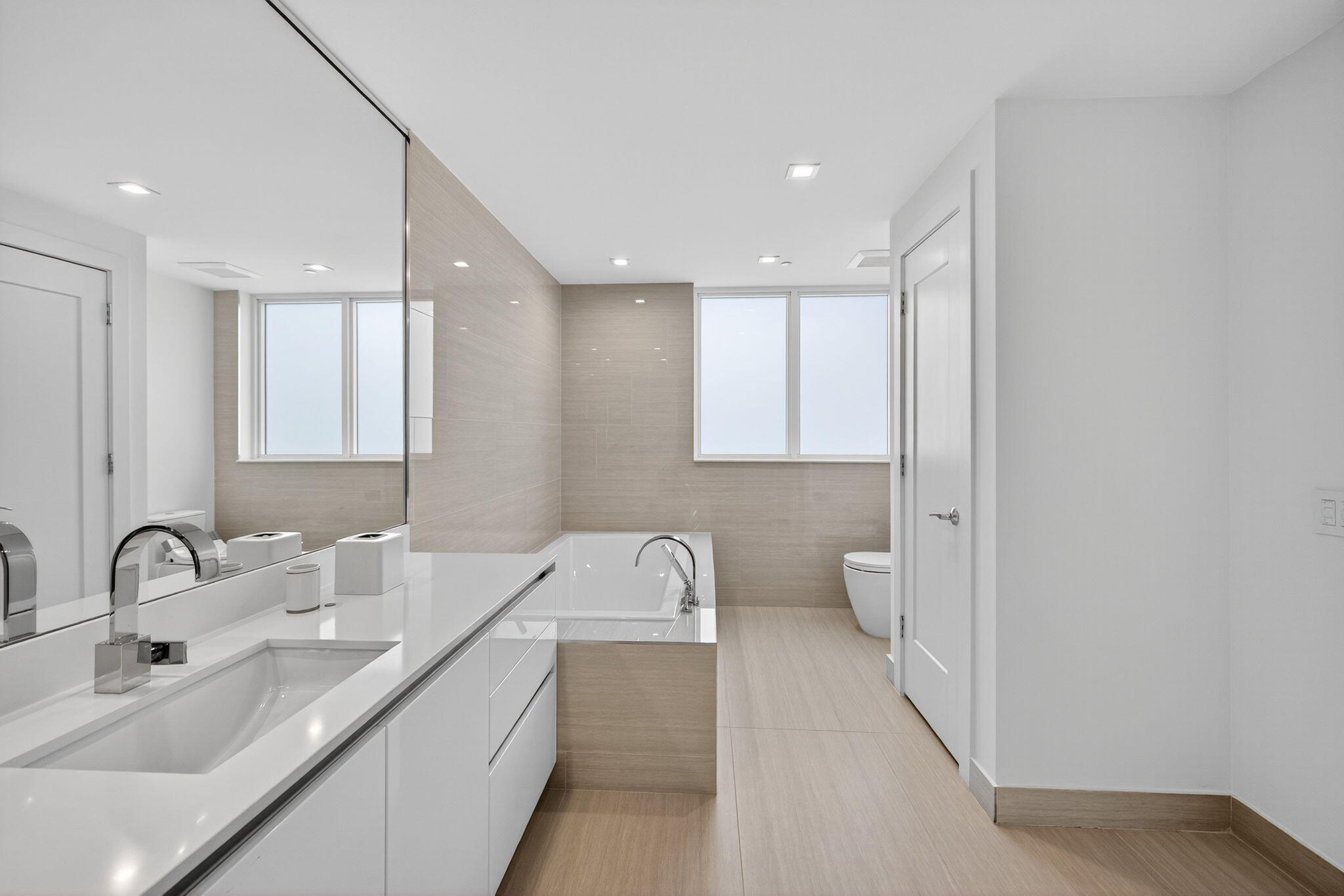 20155 Boca W Drive, Unit C302 Boca Raton, FL 33434 - Photo 14 of 78 a bathroom with a double vanity sink and a toilet