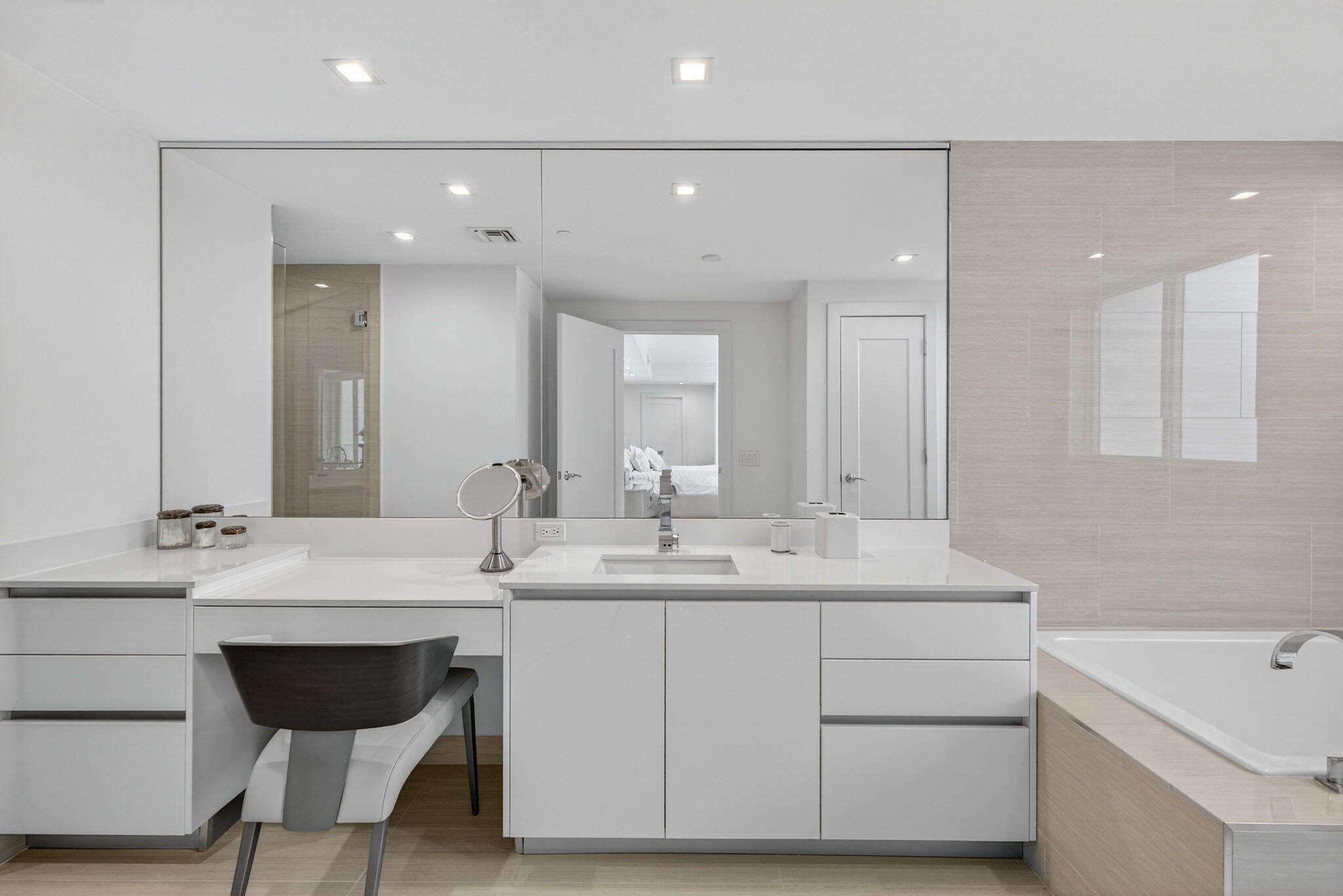 20155 Boca W Drive, Unit C302 Boca Raton, FL 33434 - Photo 18 of 78 a bathroom with a double vanity sink a mirror and a bathtub