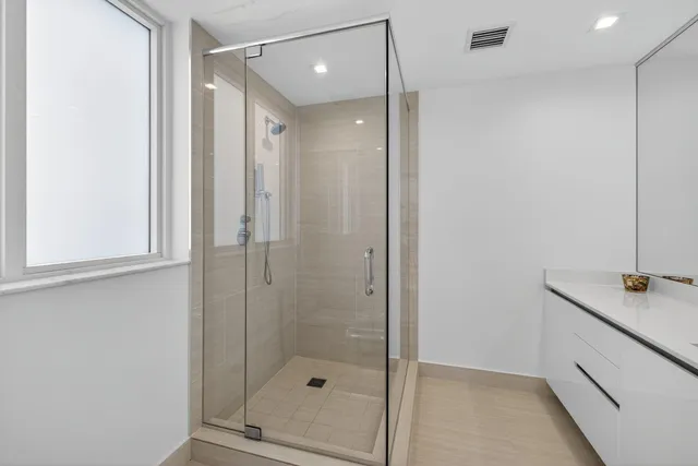 a bathroom with a shower and a sink