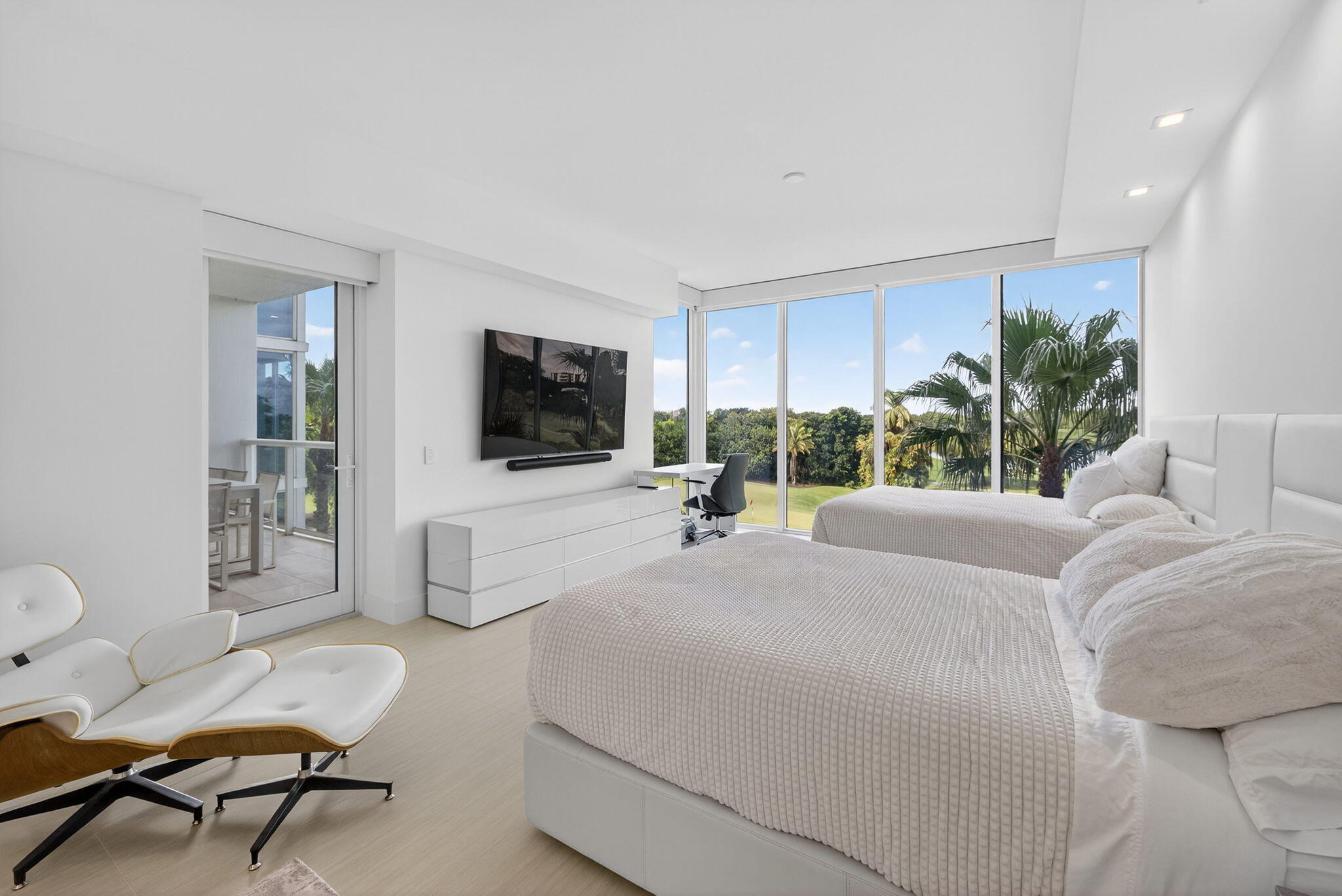 20155 Boca W Drive, Unit C302 Boca Raton, FL 33434 - Photo 25 of 78 a living room with a couch a flat screen tv and a large window