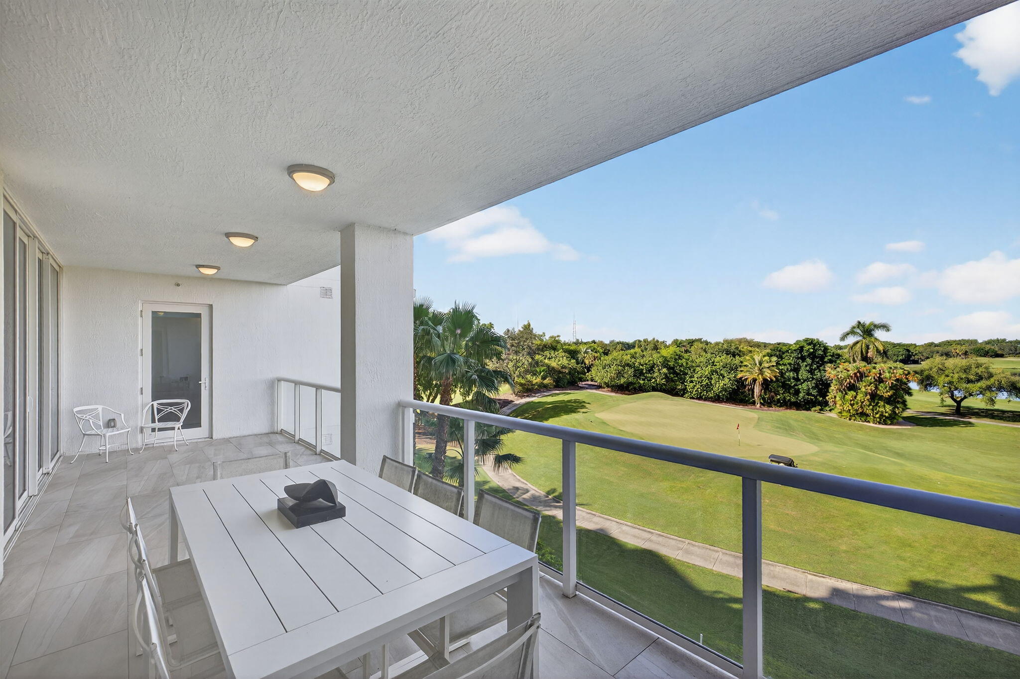 20155 Boca W Drive, Unit C302 Boca Raton, FL 33434 - Photo 35 of 78 a view of a balcony with mountain view and wooden floor
