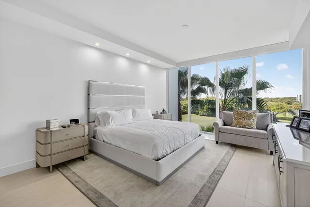 a large white kitchen with a large window