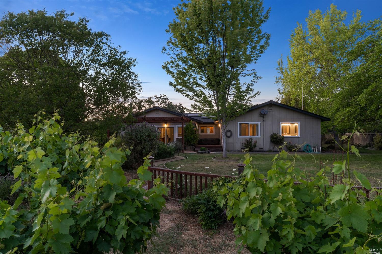a front view of house with yard and trees