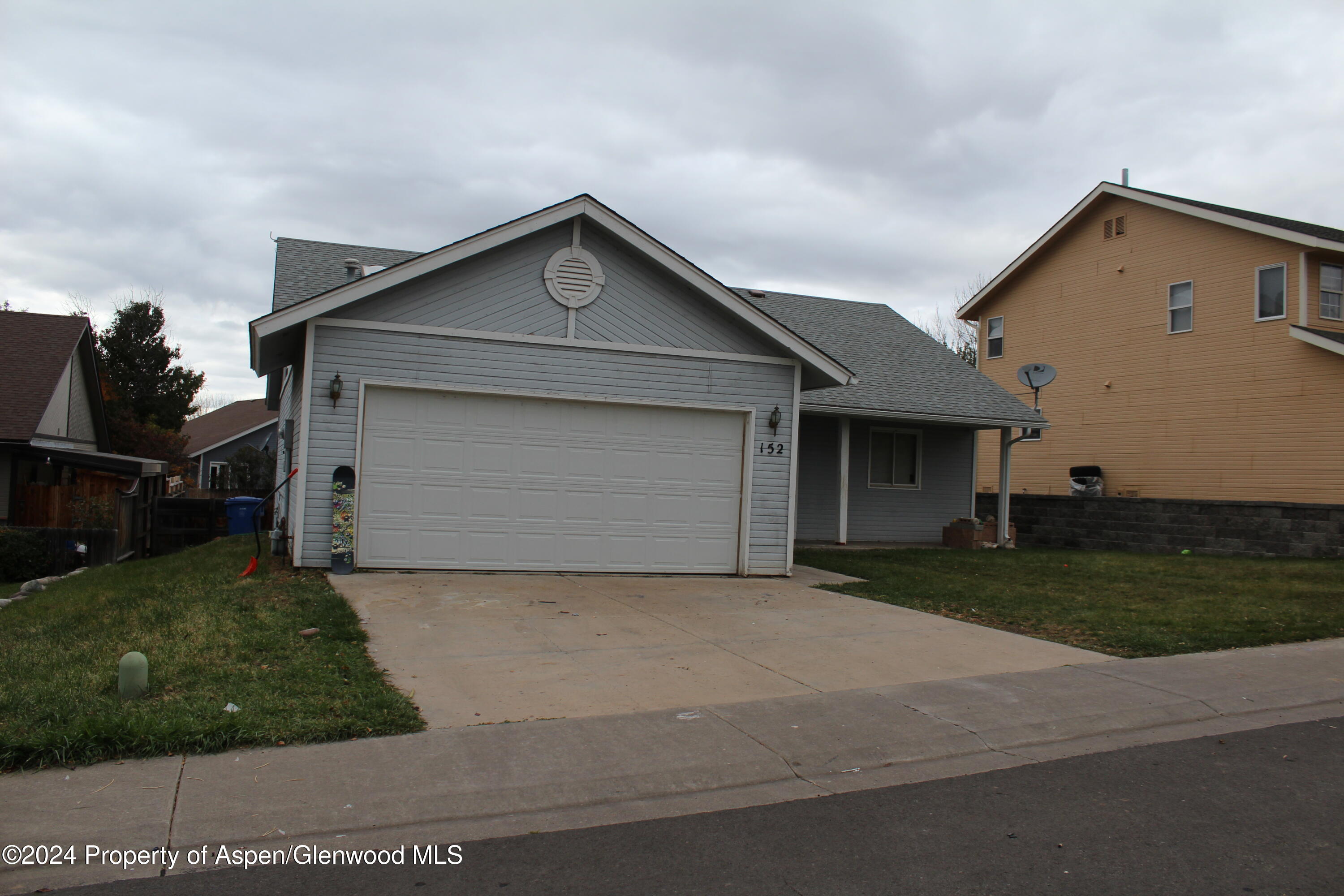152 Current Drive New Castle, CO 81647 - Photo 1 of 1 a front view of house with garage and yard