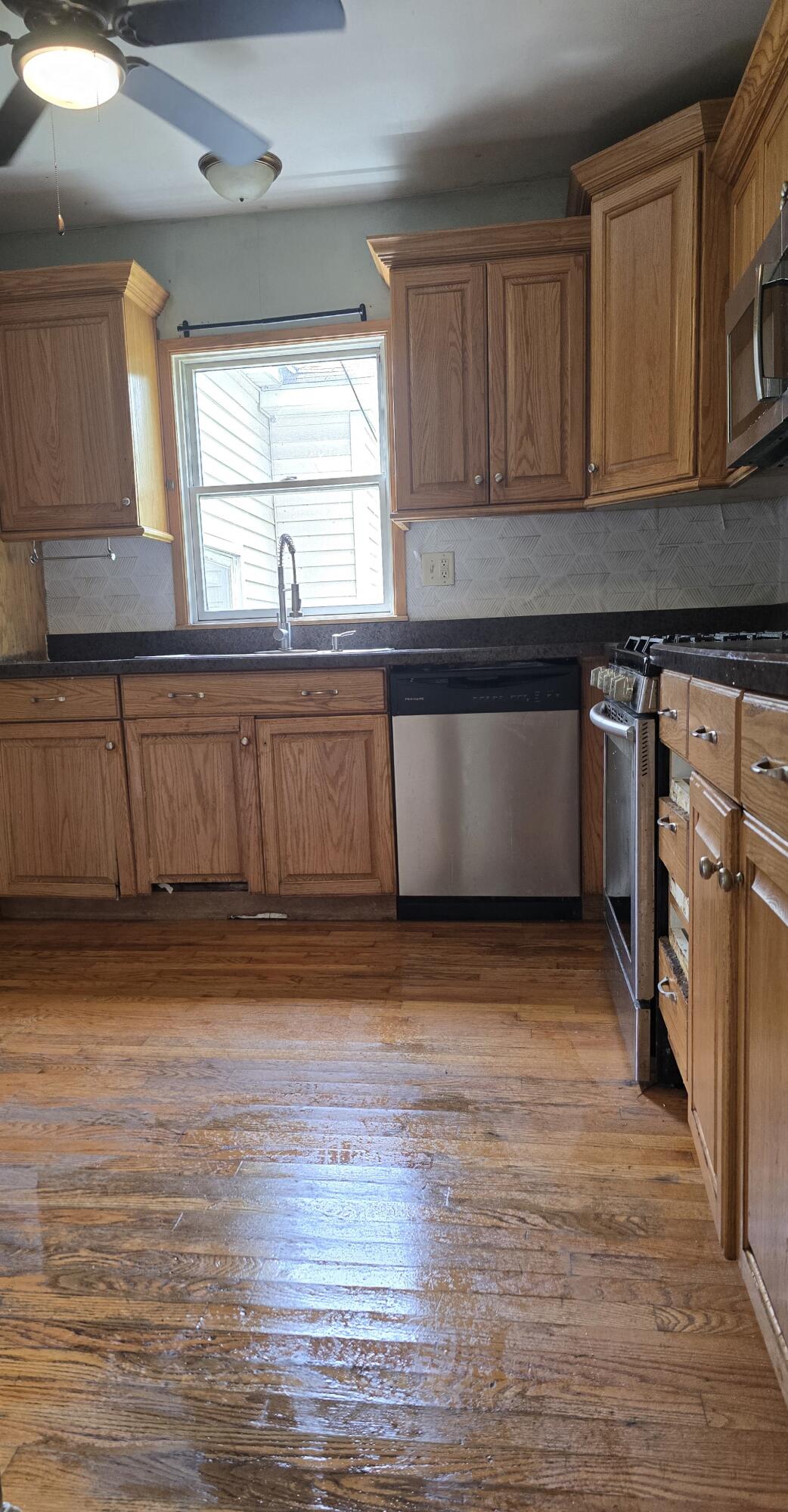 2207 North County Line Road Portage, IN 46368 - Photo 9 of 16 a kitchen with stainless steel appliances granite countertop a sink and a stove