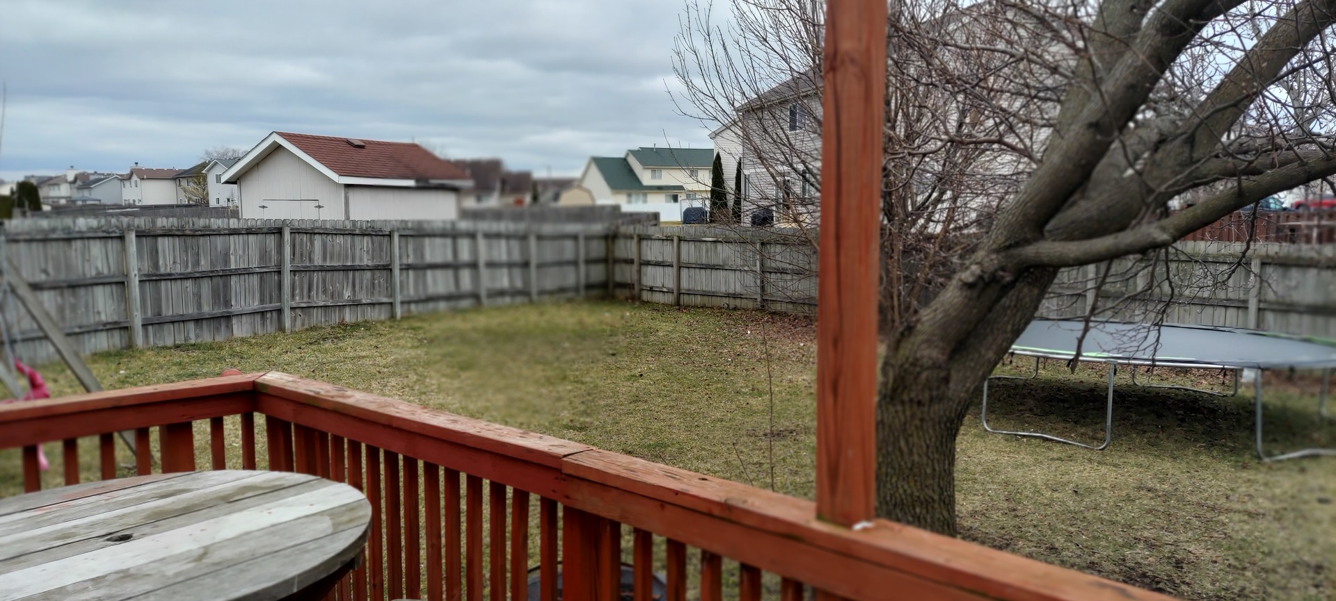 5204 Pine Trails Circle Plainfield, IL 60586 - Photo 5 of 6 a view of a wooden fence and a yard