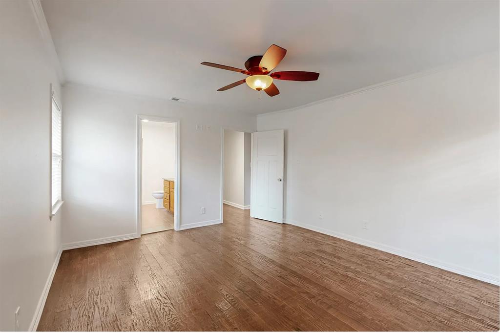 4082 Royal Lane Dallas, TX 75229 - Photo 11 of 17 an empty room with wooden floor ceiling fan and window