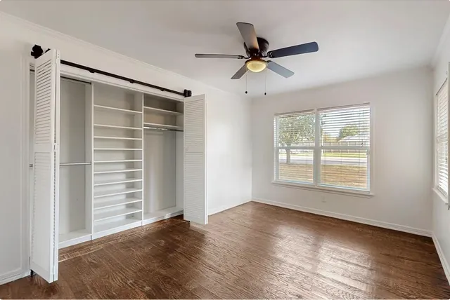 a view of a livingroom with a ceiling fan and window