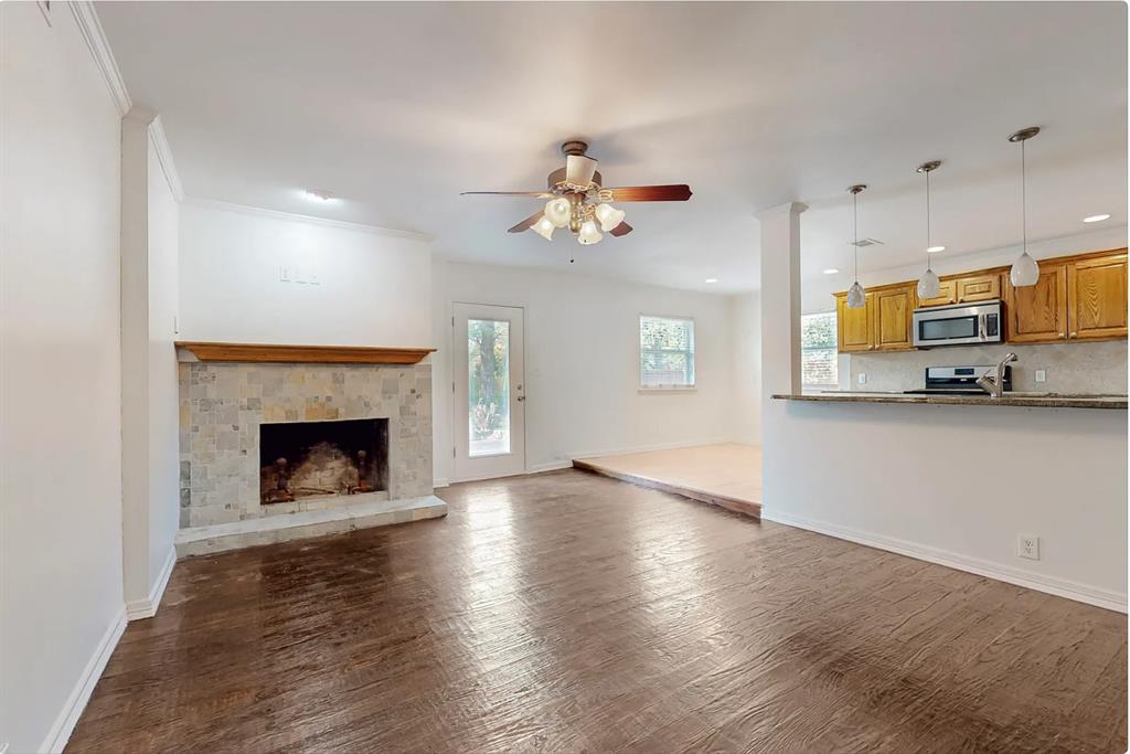 4082 Royal Lane Dallas, TX 75229 - Photo 6 of 17 a view of an empty room with a fireplace and a window