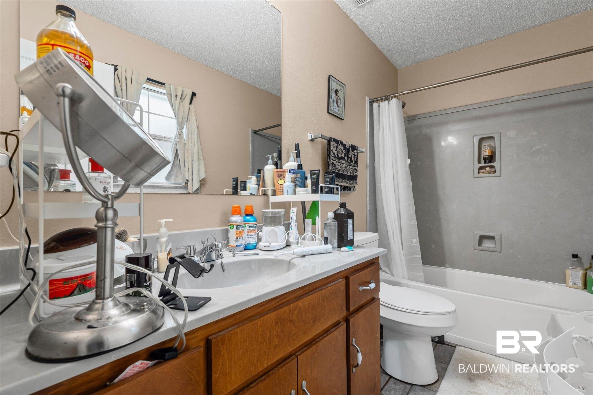 14165 River Oaks Road, Unit A & B Coden, AL 36523 - Photo 12 of 35 Full bathroom with shower / bath combo, vanity, a textured ceiling, and light tile patterned flooring